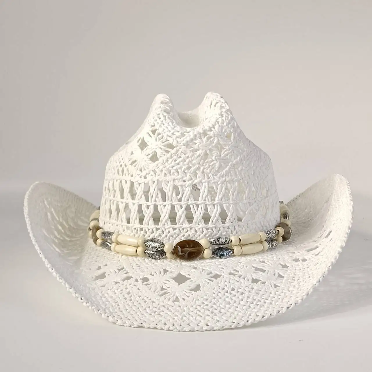 White woven iris Western cowboy hat breathable openwork design with beaded for men and women summer beach sun protection hat.
White woven iris Western cowboy hat breathable openwork design with beaded for men and women summer beach sun protection hat.