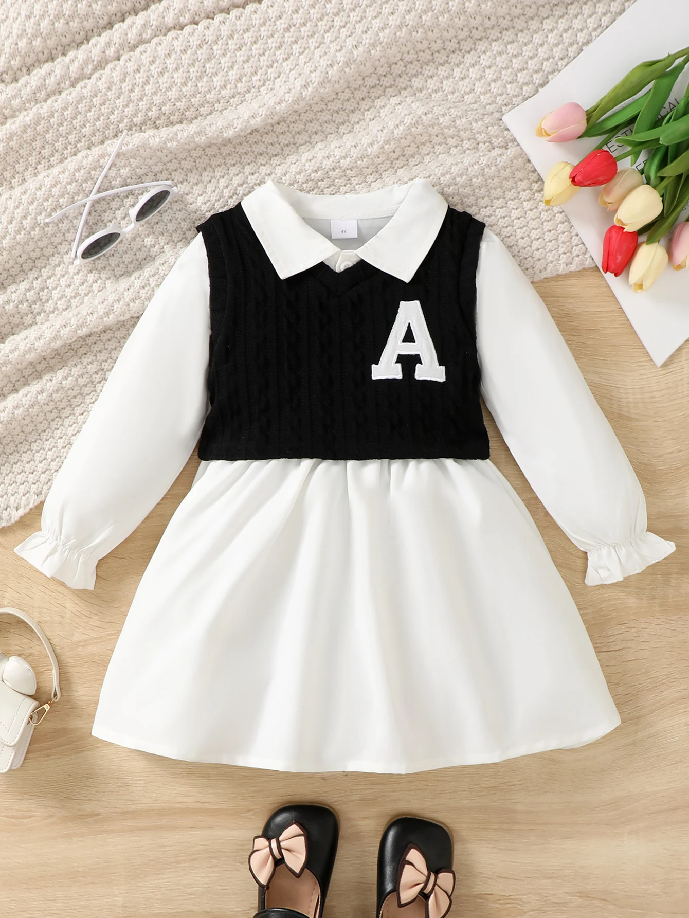 Girls' Preppy 2-in-1 Dress: White Collared Dress + Black Knit Vest with Letter "A", Stylish Daily Outfit.
Girls' Preppy 2-in-1 Dress: White Collared Dress + Black Knit Vest with Letter "A", Stylish Daily Outfit.