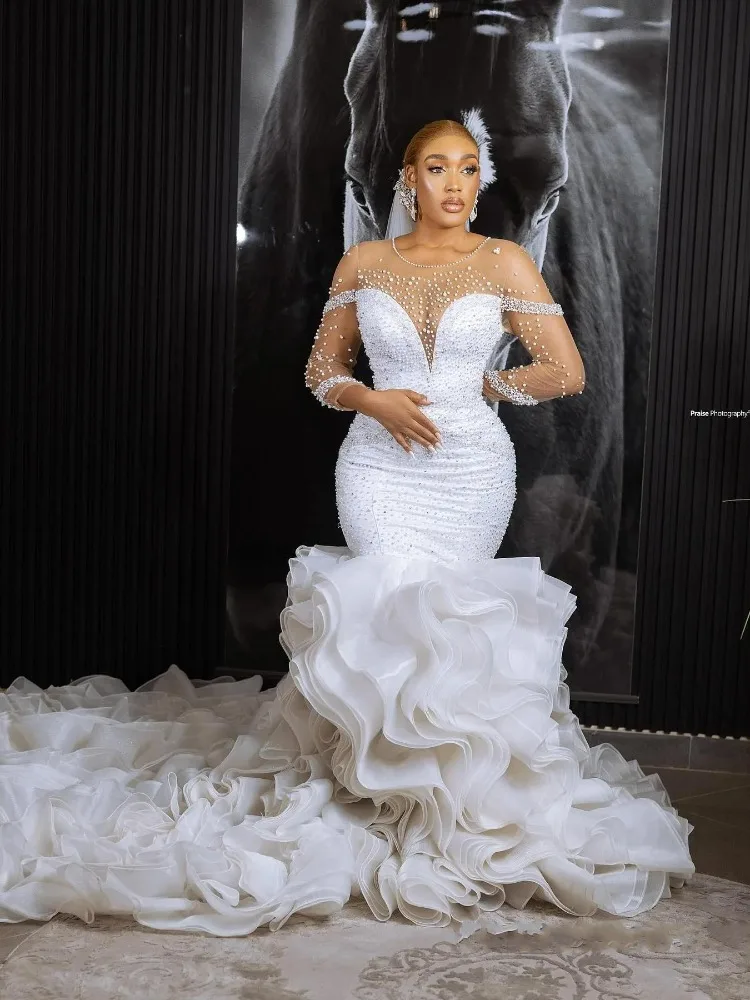 Luxury Pearls Beads Mermaid Wedding Dress O-neck Long Sleeves Ruffles Open Back African Garden Bridal Gowns Vestido De Novia
Luxury Pearls Beads Mermaid Wedding Dress O-neck Long Sleeves Ruffles Open Back African Garden Bridal Gowns Vestido De Novia