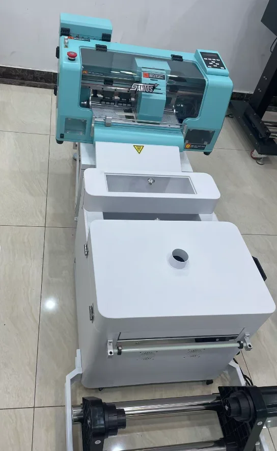 Текстильный DTF-принтер для футболок 30 см с головками XP600 I1600a1, шейкером для порошка и печью, недорогой DTF-принтер A3 Hoson
Текстильный DTF-принтер для футболок 30 см с головками XP600 I1600a1, шейкером для порошка и печью, недорогой DTF-принтер A3 Hoson