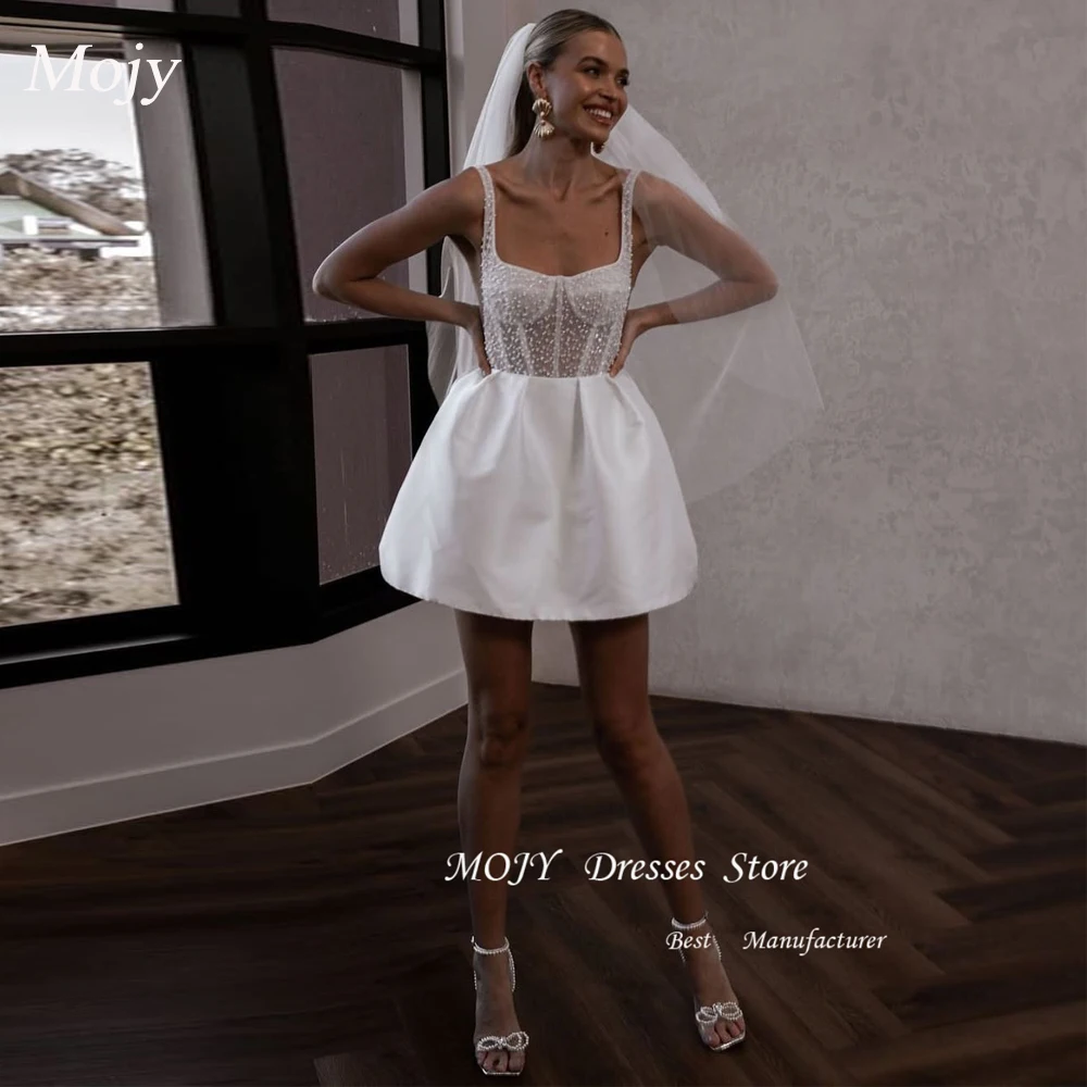 Mojy Customized Mini Ball Gown High Waist Wedding Dress Square Collar Pearls Spaghetti Strap Sexy Backless Button Wedding Gown 
Mojy Customized Mini Ball Gown High Waist Wedding Dress Square Collar Pearls Spaghetti Strap Sexy Backless Button Wedding Gown