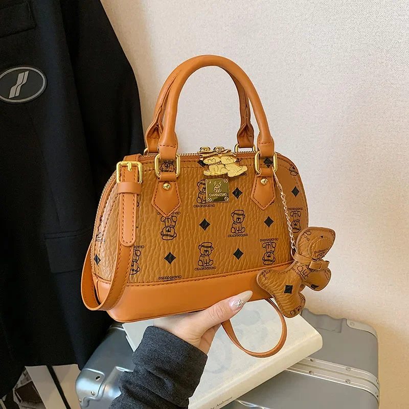 2025 Ladies' High-Quality Shell Crossbody Bag | Bear Print Mini Messenger with Faux Leather Texture | Niche Temperament Handbag
2025 Ladies' High-Quality Shell Crossbody Bag | Bear Print Mini Messenger with Faux Leather Texture | Niche Temperament Handbag