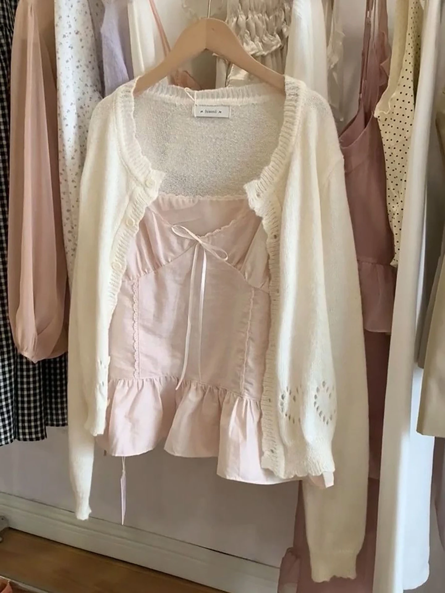 Pastel Knitted Cardigan with Bow Pink Strap Top Two-Piece Set Elegant Commuter Chic Beige Spring Fashion Ensemble
Pastel Knitted Cardigan with Bow Pink Strap Top Two-Piece Set Elegant Commuter Chic Beige Spring Fashion Ensemble