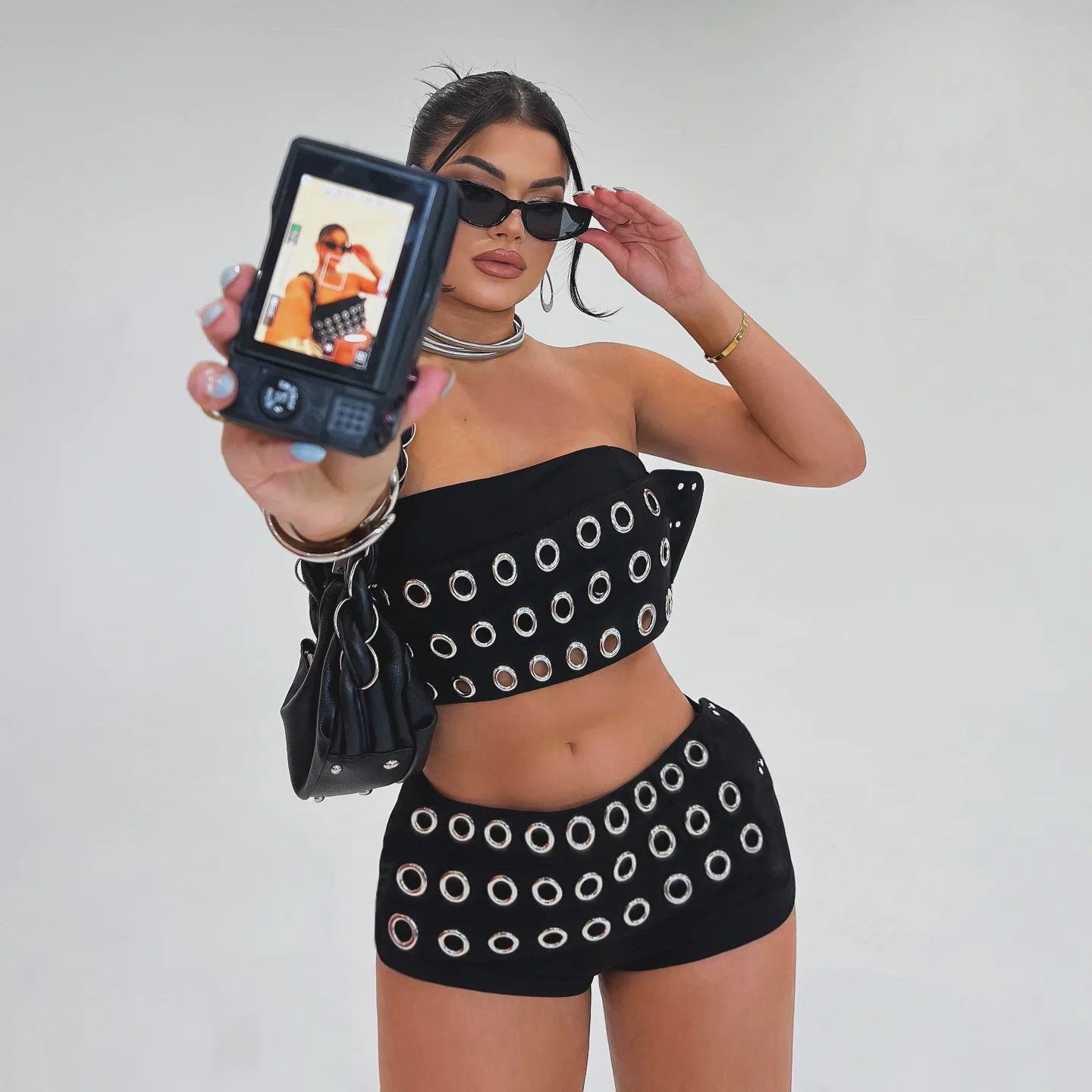 Sexy Grommet Eyelet Two-Piece Set Women Metal Ring Strapless Crop Top And High Waist Shorts Clubwear Rave Outfits
Sexy Grommet Eyelet Two-Piece Set Women Metal Ring Strapless Crop Top And High Waist Shorts Clubwear Rave Outfits