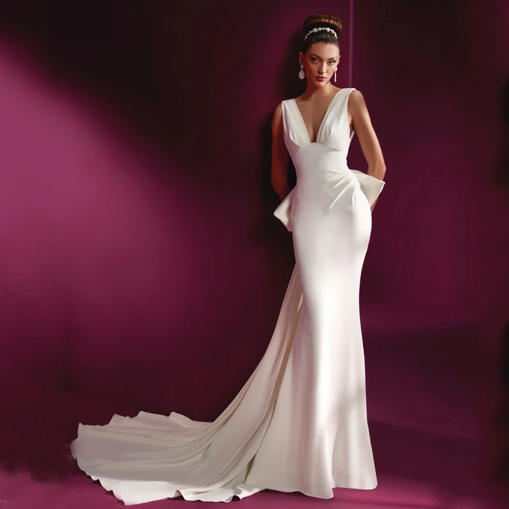 Elegant Sleeveless V-Neck Mermaid Wedding Dress Bridal Pleat with Bow Sexy Open Back Jersey Floor Length Bride Marriage Gowns
Elegant Sleeveless V-Neck Mermaid Wedding Dress Bridal Pleat with Bow Sexy Open Back Jersey Floor Length Bride Marriage Gowns