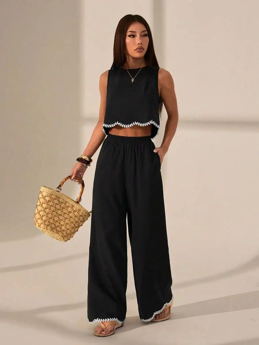 Black Sleeveless Crop Top And Wide-Leg Pants Featuring White Leaf-Embroidered Trim At Hem And Cuffs, Casual Two-Piece Summer Set
Black Sleeveless Crop Top And Wide-Leg Pants Featuring White Leaf-Embroidered Trim At Hem And Cuffs, Casual Two-Piece Summer Set