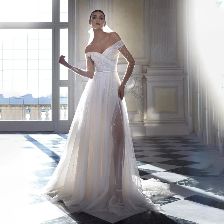 Customized Radiant Sequin Tulle Wedding Dress Off-the-Shoulder Long Sleeves Glistening Bridal Gown Features Split Design Train
Customized Radiant Sequin Tulle Wedding Dress Off-the-Shoulder Long Sleeves Glistening Bridal Gown Features Split Design Train