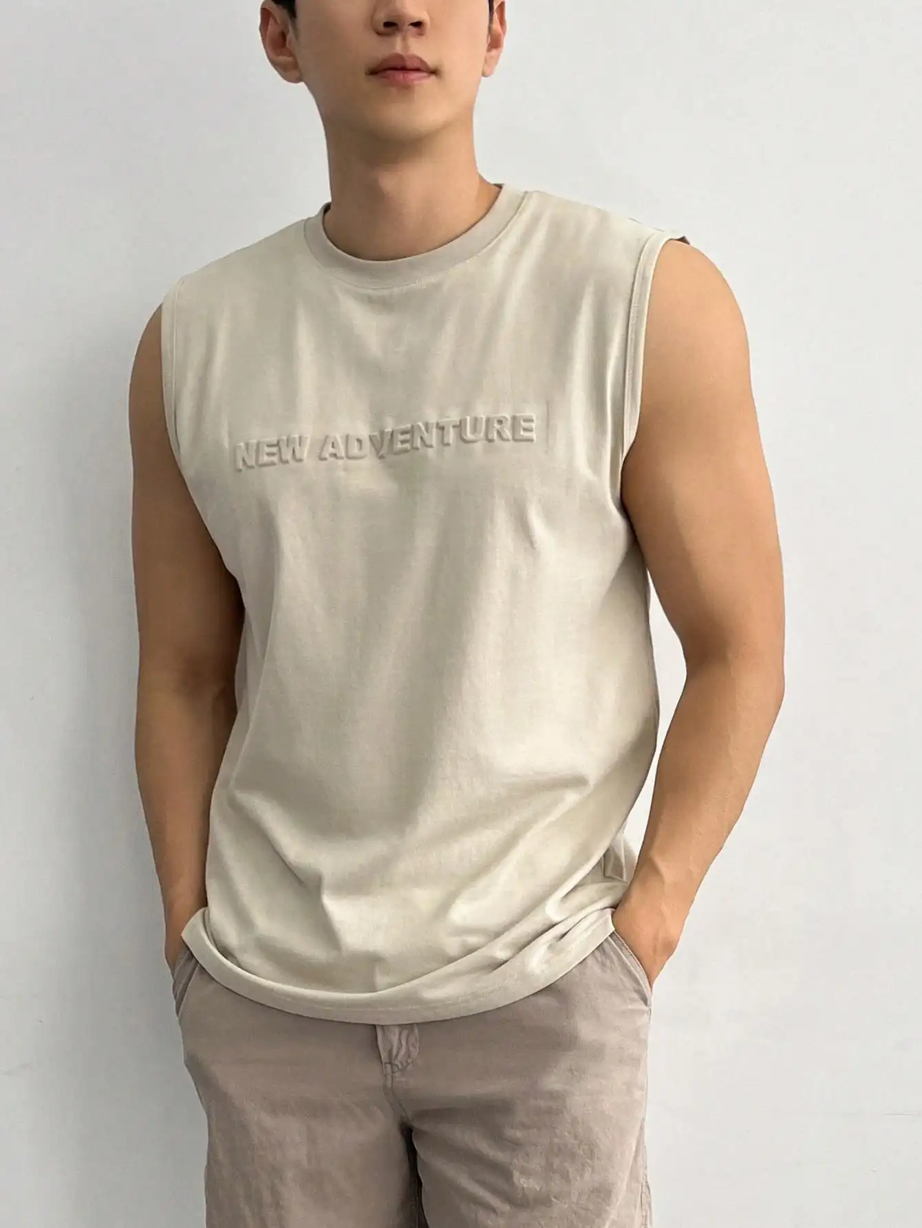 Men's Beige Sleeveless Round Neck Tank Top with Embossed Text Design
Men's Beige Sleeveless Round Neck Tank Top with Embossed Text Design