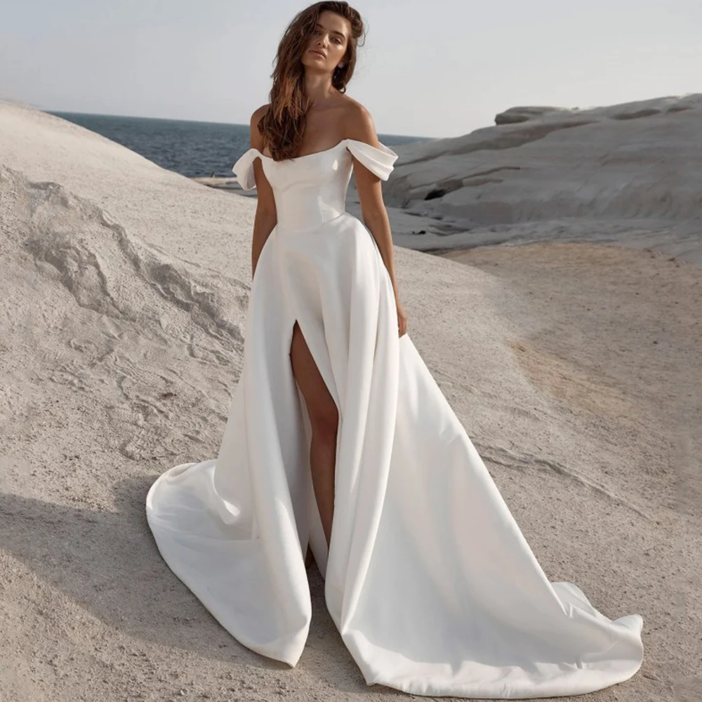 Sexy Side Slit Bridal A-Line Wedding Dress Simple Satin Boat Neck and Off the Shoulder Short Sleeves Open Back Bride Gowns
Sexy Side Slit Bridal A-Line Wedding Dress Simple Satin Boat Neck and Off the Shoulder Short Sleeves Open Back Bride Gowns