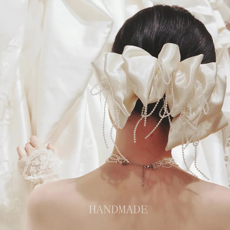 Новый свадебный головной убор в стиле ретро с жемчужной кисточкой и большим бантом для женщин
Новый свадебный головной убор в стиле ретро с жемчужной кисточкой и большим бантом для женщин
