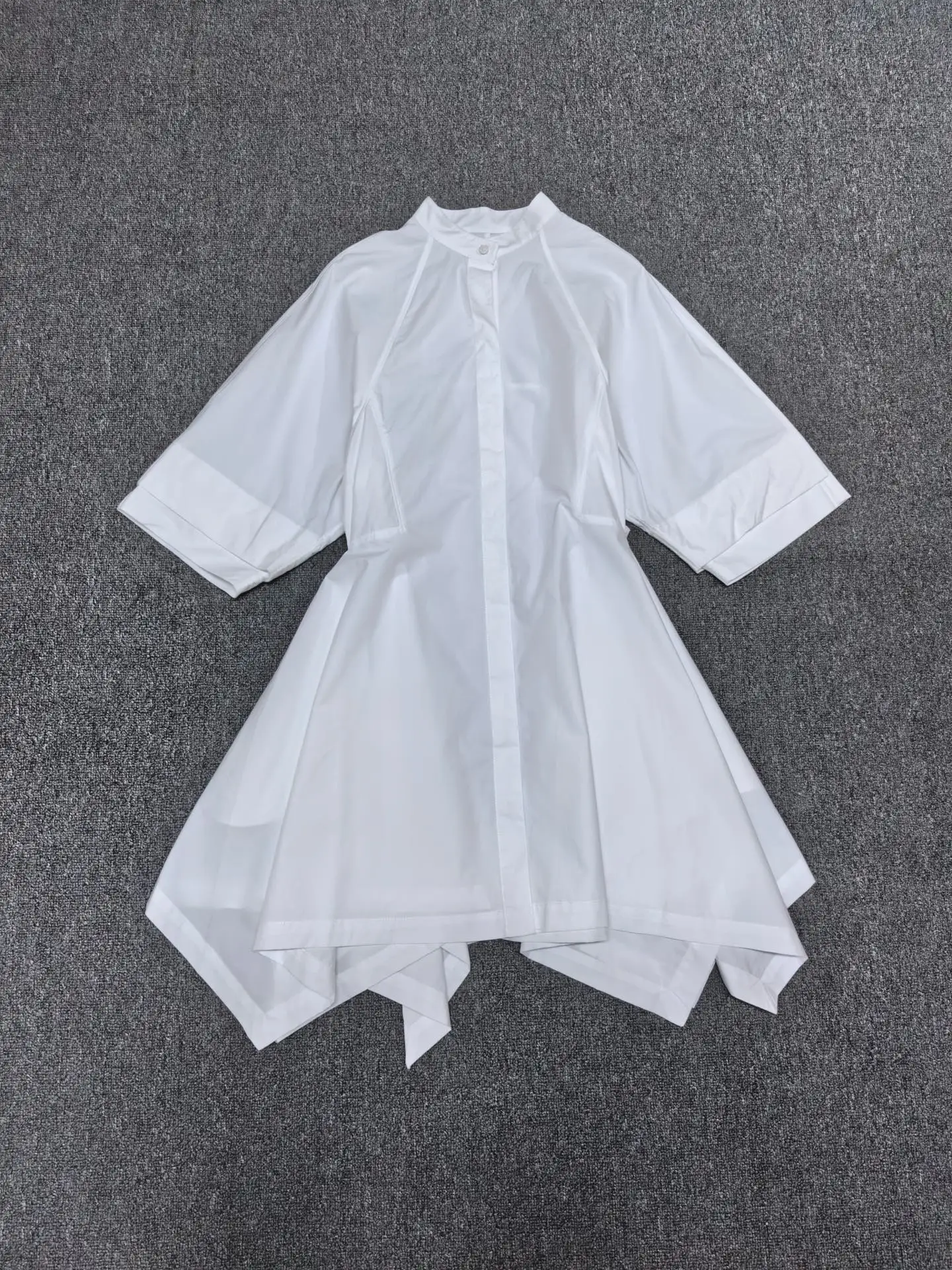 Blouse dress with stand-up collar and waistline for women. Irregular hemline for a casual short skirt. 2026 summer new style.
Blouse dress with stand-up collar and waistline for women. Irregular hemline for a casual short skirt. 2026 summer new style.