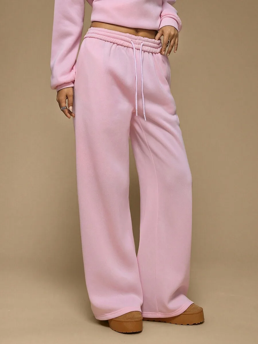 Розовые свободные спортивные брюки с широкими штанинами и эластичным поясом для повседневной носки
Розовые свободные спортивные брюки с широкими штанинами и эластичным поясом для повседневной носки