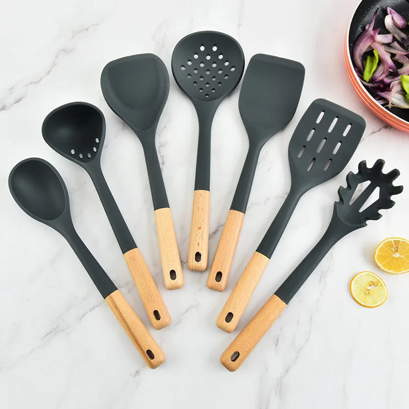 Silicone kitchenware set with wooden handles. Kitchen tools: silicone spatula, strainer, frying spatula
Silicone kitchenware set with wooden handles. Kitchen tools: silicone spatula, strainer, frying spatula