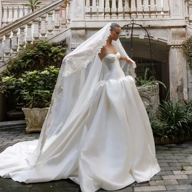 Strapless Sweetheart Satin Ball Gown Wedding Dress High Waist Sculptural Skirt Matching Lace Veil Cathedral Train Customizable
Strapless Sweetheart Satin Ball Gown Wedding Dress High Waist Sculptural Skirt Matching Lace Veil Cathedral Train Customizable