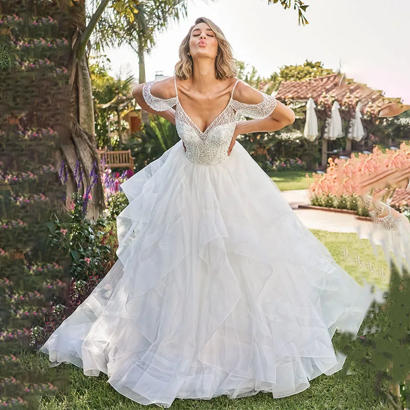 Bohemia Beaded Around Neck Spaghetti Straps Wedding Dresses Backless Ruffles Organza Bridal Gown
Bohemia Beaded Around Neck Spaghetti Straps Wedding Dresses Backless Ruffles Organza Bridal Gown