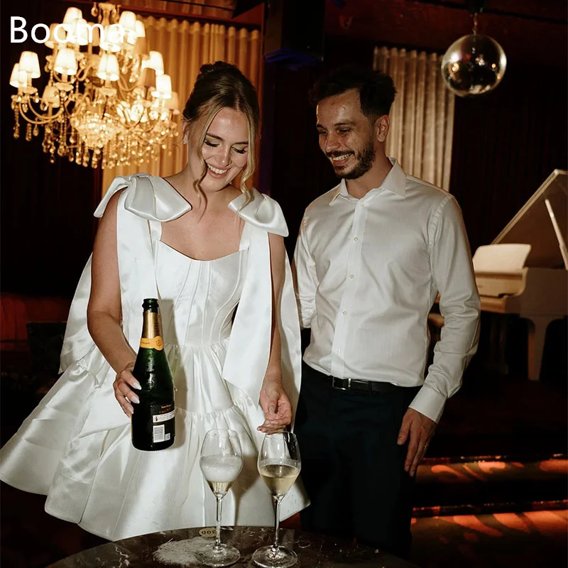 Booma Elegant Wedding Dresses Off The Shoulder Sleeveless Satin Mini A-Line Bow Brides Gown Custom Made 2025
Booma Elegant Wedding Dresses Off The Shoulder Sleeveless Satin Mini A-Line Bow Brides Gown Custom Made 2025