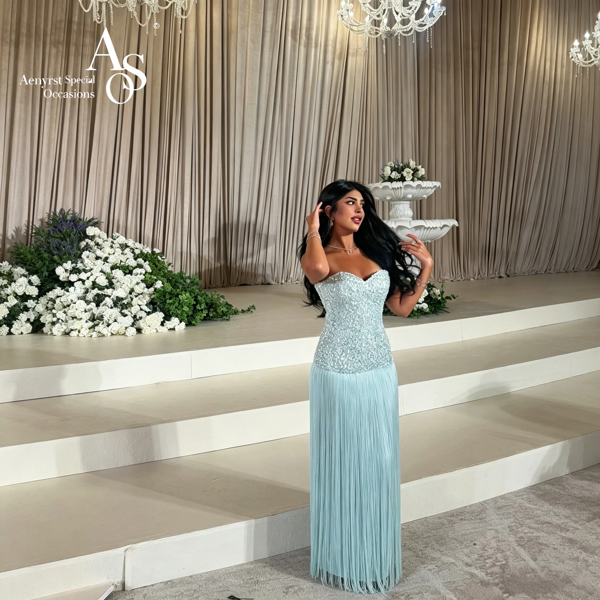 Exquisite blue strapless sleeveless floor-length formal gown featuring beadwork and fringe detailing
Exquisite blue strapless sleeveless floor-length formal gown featuring beadwork and fringe detailing