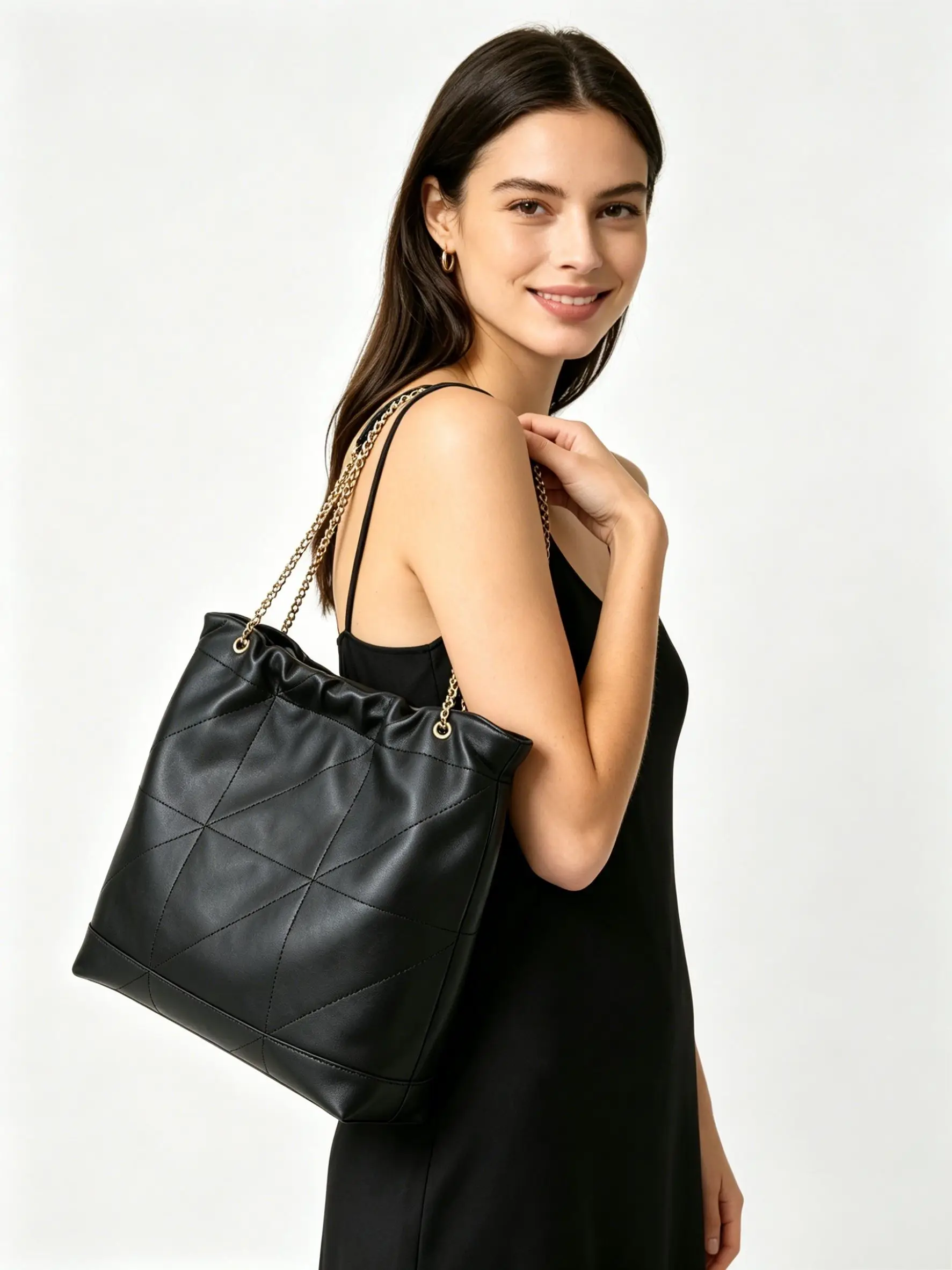 Casual-chic black tote crafted from soft quilted leather, featuring diamond stitching, gold-tone chain straps, and a relaxed, roomy silhouette.
Casual-chic black tote crafted from soft quilted leather, featuring diamond stitching, gold-tone chain straps, and a relaxed, roomy silhouette.