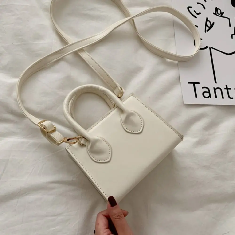 Маленькая квадратная сумка из искусственной кожи, однотонная, с верхней ручкой, мини-сумочка, минималистичная, с регулируемыми ремнями, женская сумка через плечо
Маленькая квадратная сумка из искусственной кожи, однотонная, с верхней ручкой, мини-сумочка, минималистичная, с регулируемыми ремнями, женская сумка через плечо