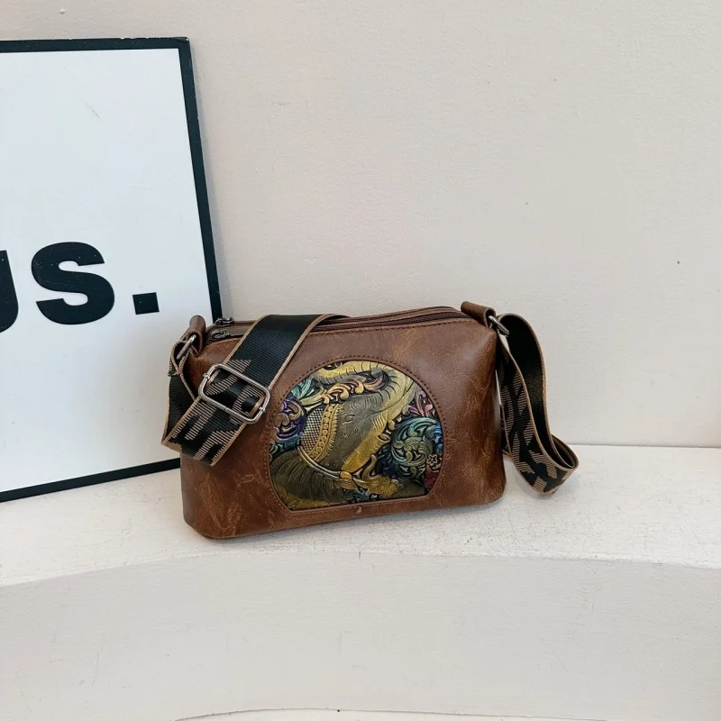 Vintage-style crossbody bag with colorful embossed detail & adjustable strap, relaxed silhouette for all occasions
Vintage-style crossbody bag with colorful embossed detail & adjustable strap, relaxed silhouette for all occasions