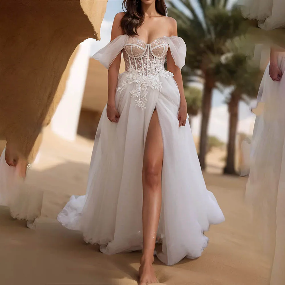 Charming Off-The-Shoulder Sweetheart Lace Applique A-Line Bridal Gown with Side Slit 2026 Rode De Morrie Wedding Dress
Charming Off-The-Shoulder Sweetheart Lace Applique A-Line Bridal Gown with Side Slit 2026 Rode De Morrie Wedding Dress