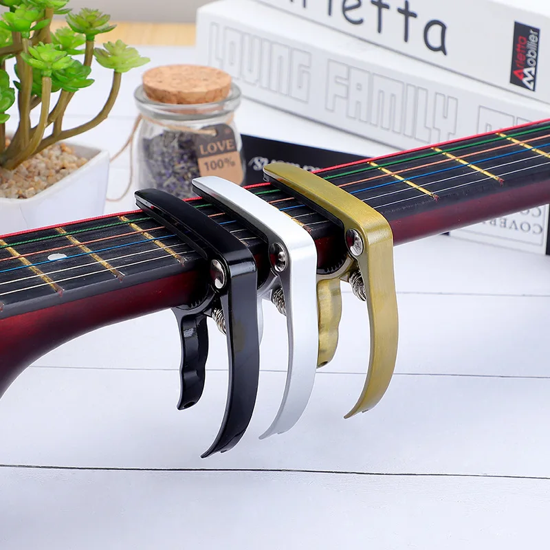 Metal Guitar Capo Zinc Alloy folk Guitar Tuner Clamp Professional Key Trigger Capo For Acoustic Musical Instruments accessories
Metal Guitar Capo Zinc Alloy folk Guitar Tuner Clamp Professional Key Trigger Capo For Acoustic Musical Instruments accessories
