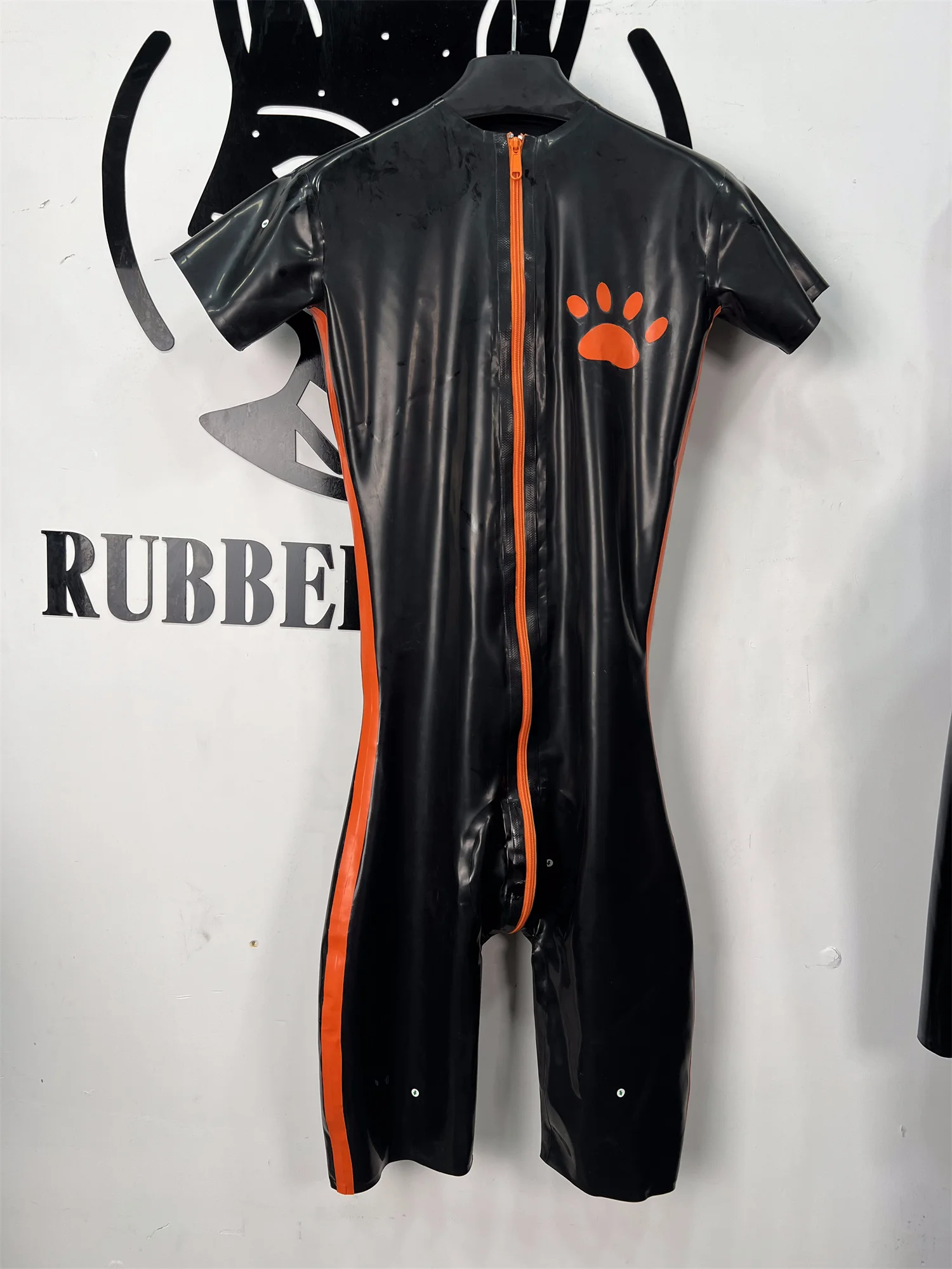 Black Rubber Knee‑Length Bodysuit for Men Durable Short Catsuit with Orange Paw Print
Black Rubber Knee‑Length Bodysuit for Men Durable Short Catsuit with Orange Paw Print