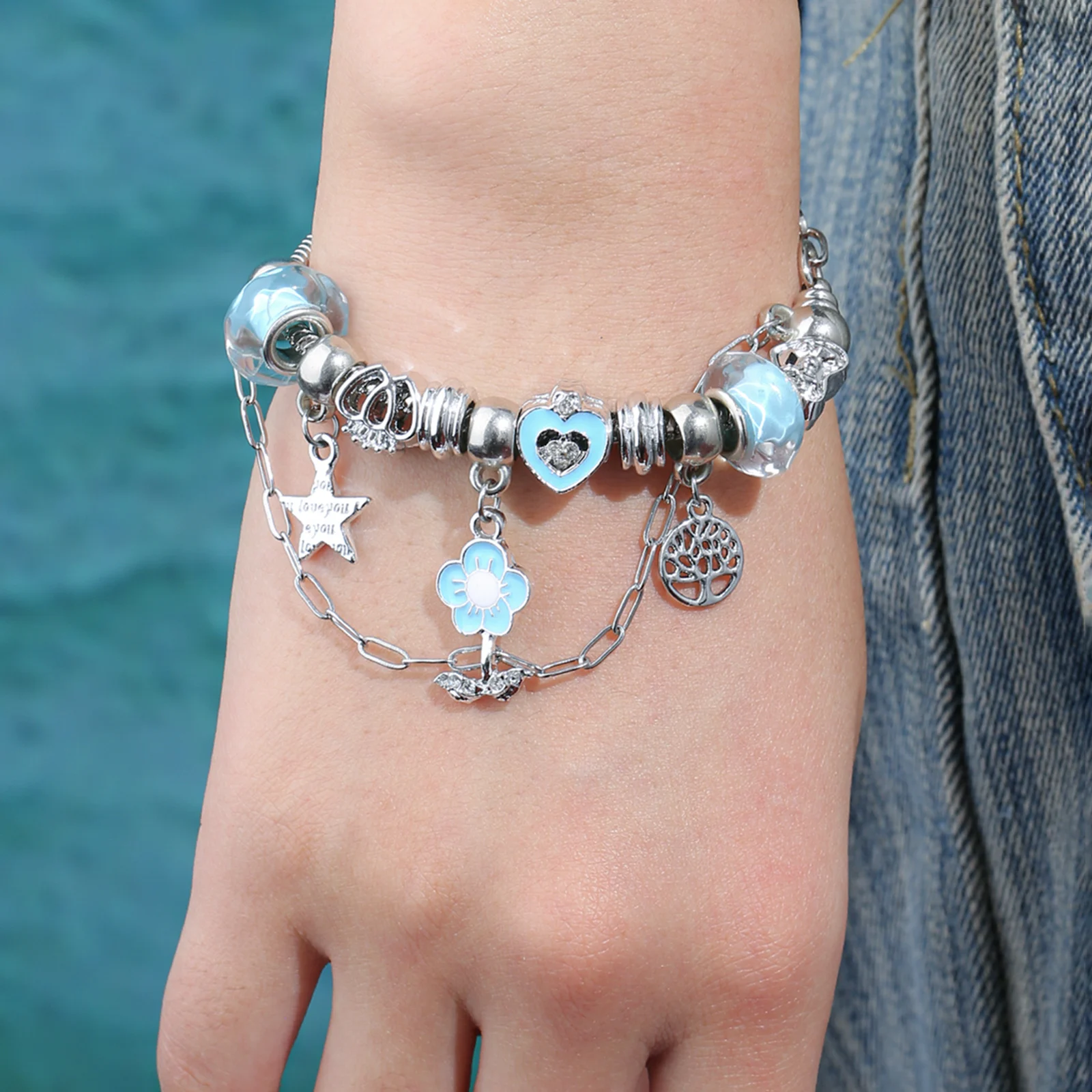 Silver Tone Charm Bracelet with Blue Enamel Flower and Heart Beads for Women
Silver Tone Charm Bracelet with Blue Enamel Flower and Heart Beads for Women