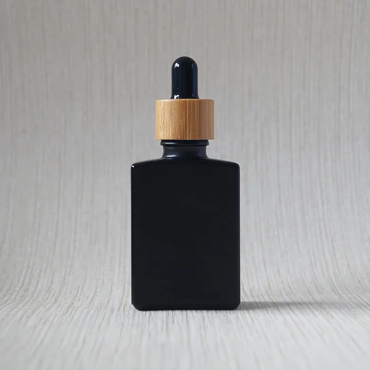 Custom wholesale square food grade black frosted square rectangle essential oil glass dropper bottle with wooden bamboo cap
Custom wholesale square food grade black frosted square rectangle essential oil glass dropper bottle with wooden bamboo cap