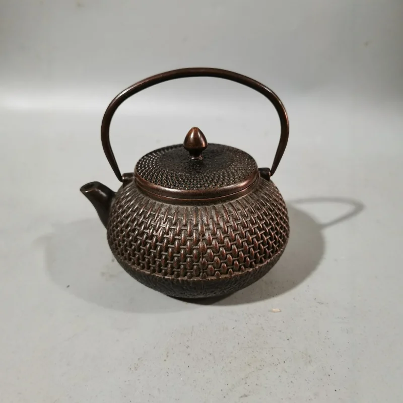 Antique and vintage market items: aged copper and brass wine flask with handle, teapot, and copper kettle as decorative pieces
Antique and vintage market items: aged copper and brass wine flask with handle, teapot, and copper kettle as decorative pieces