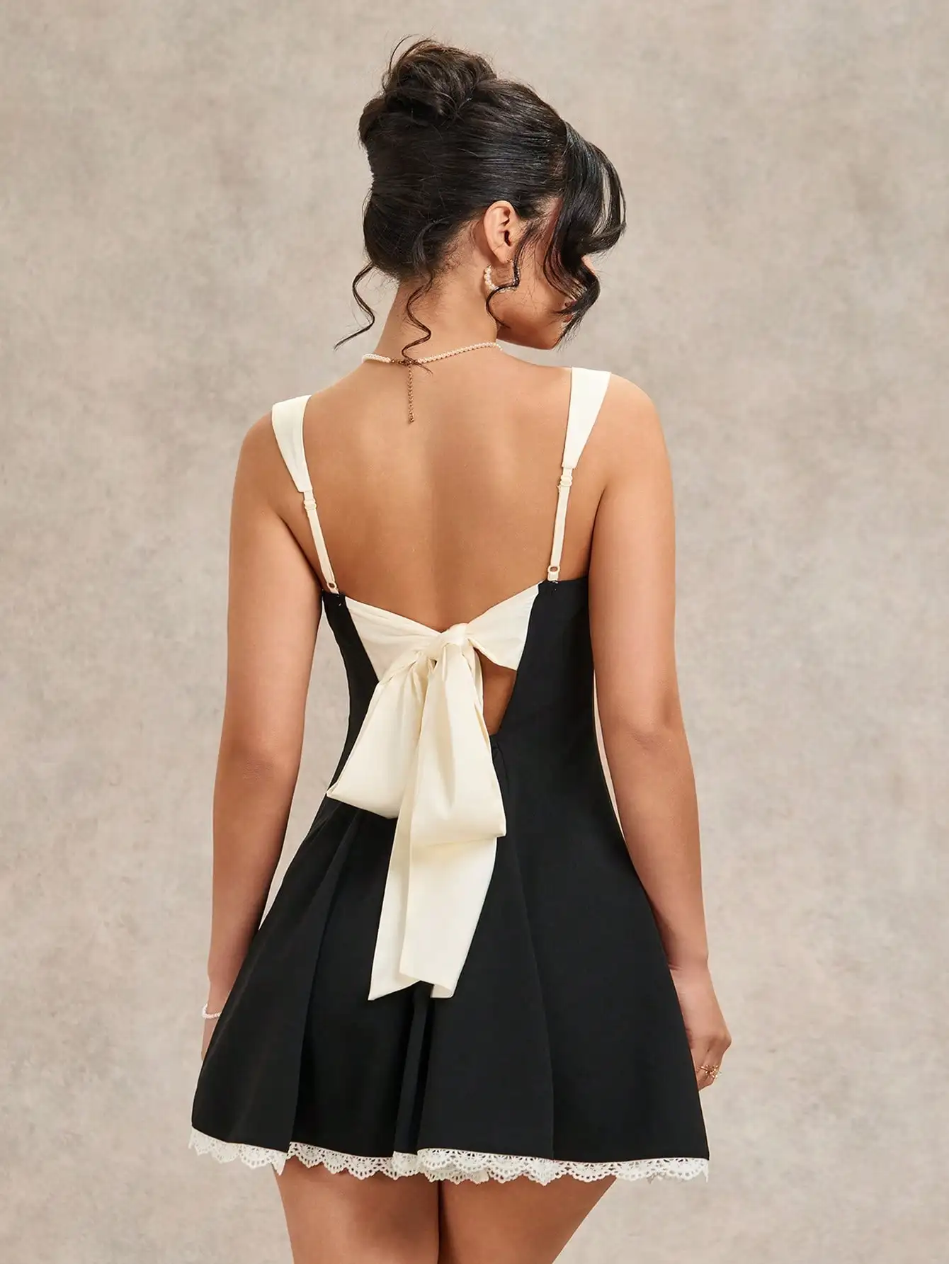 Black and White Backless Mini Dress with Bow Detail, Lace Hem, for Date Night, Parties, Festivals
Black and White Backless Mini Dress with Bow Detail, Lace Hem, for Date Night, Parties, Festivals