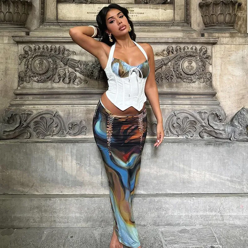 SKMY Сексуальный укороченный топ с лямкой на шее и облегающий модный комплект юбки-миди, высококачественная модная повседневная женская одежда 2025 года
SKMY Сексуальный укороченный топ с лямкой на шее и облегающий модный комплект юбки-миди, высококачественная модная повседневная женская одежда 2025 года