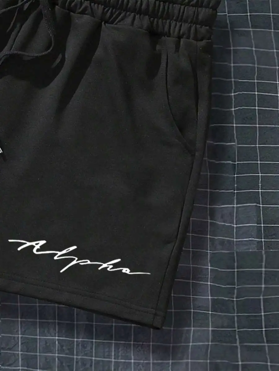 Mens Black Shorts With White Cursive Alpha Print, Elastic Waist Drawstring Design For Beach Or Casual Wear
Mens Black Shorts With White Cursive Alpha Print, Elastic Waist Drawstring Design For Beach Or Casual Wear