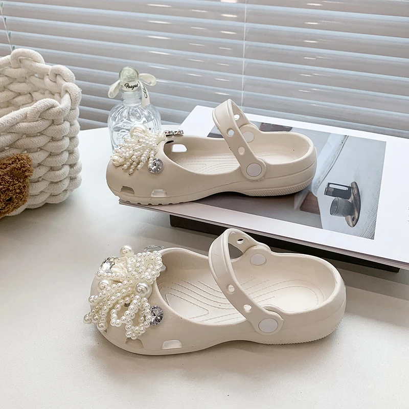 A pair of children's mary jane clogs non slip soft sole sandals with detachable pearl bow charms MM-692-678
A pair of children's mary jane clogs non slip soft sole sandals with detachable pearl bow charms MM-692-678