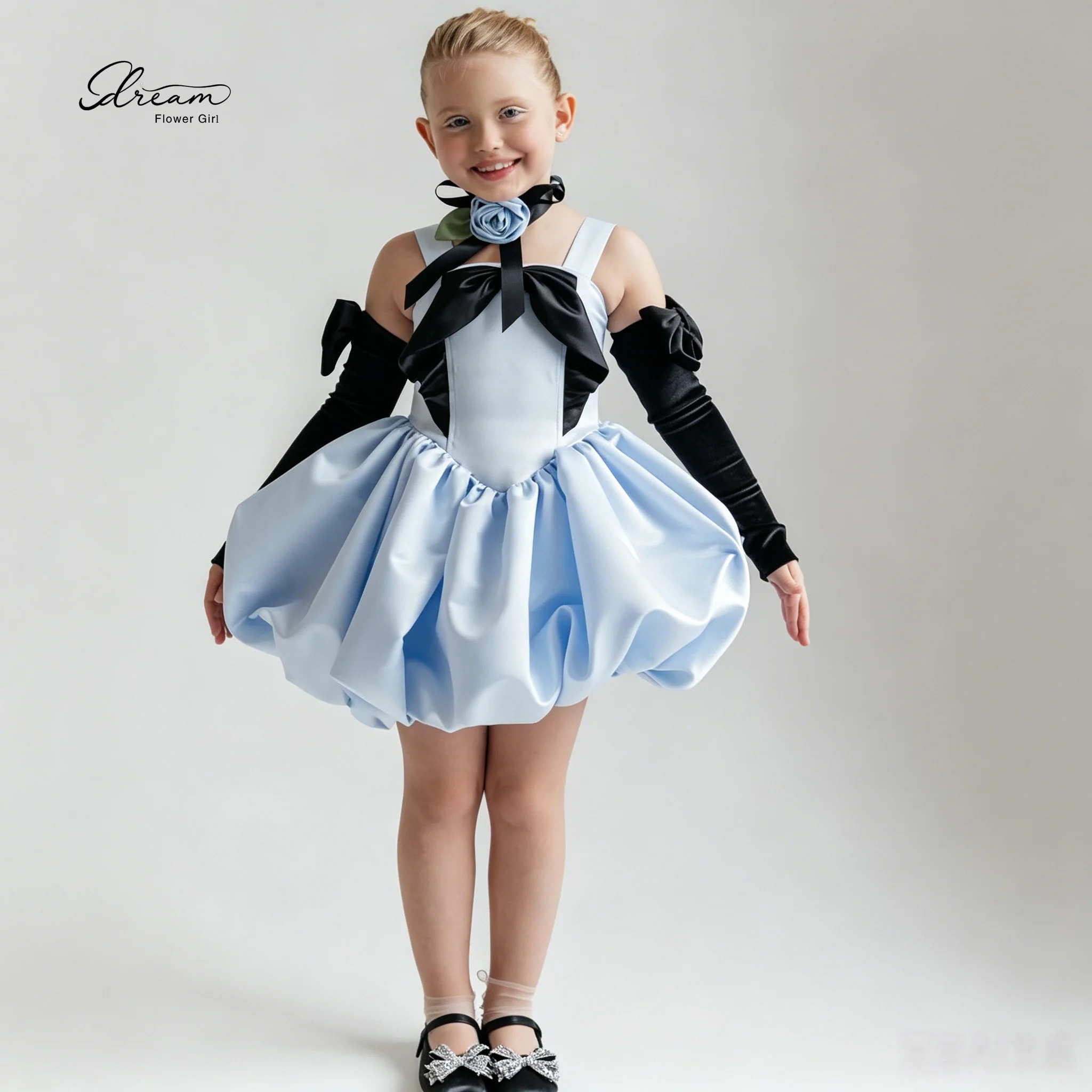 Blue sleeveless formal dress for girls featuring spaghetti straps a knee-length full skirt and a bubble-style hem
Blue sleeveless formal dress for girls featuring spaghetti straps a knee-length full skirt and a bubble-style hem