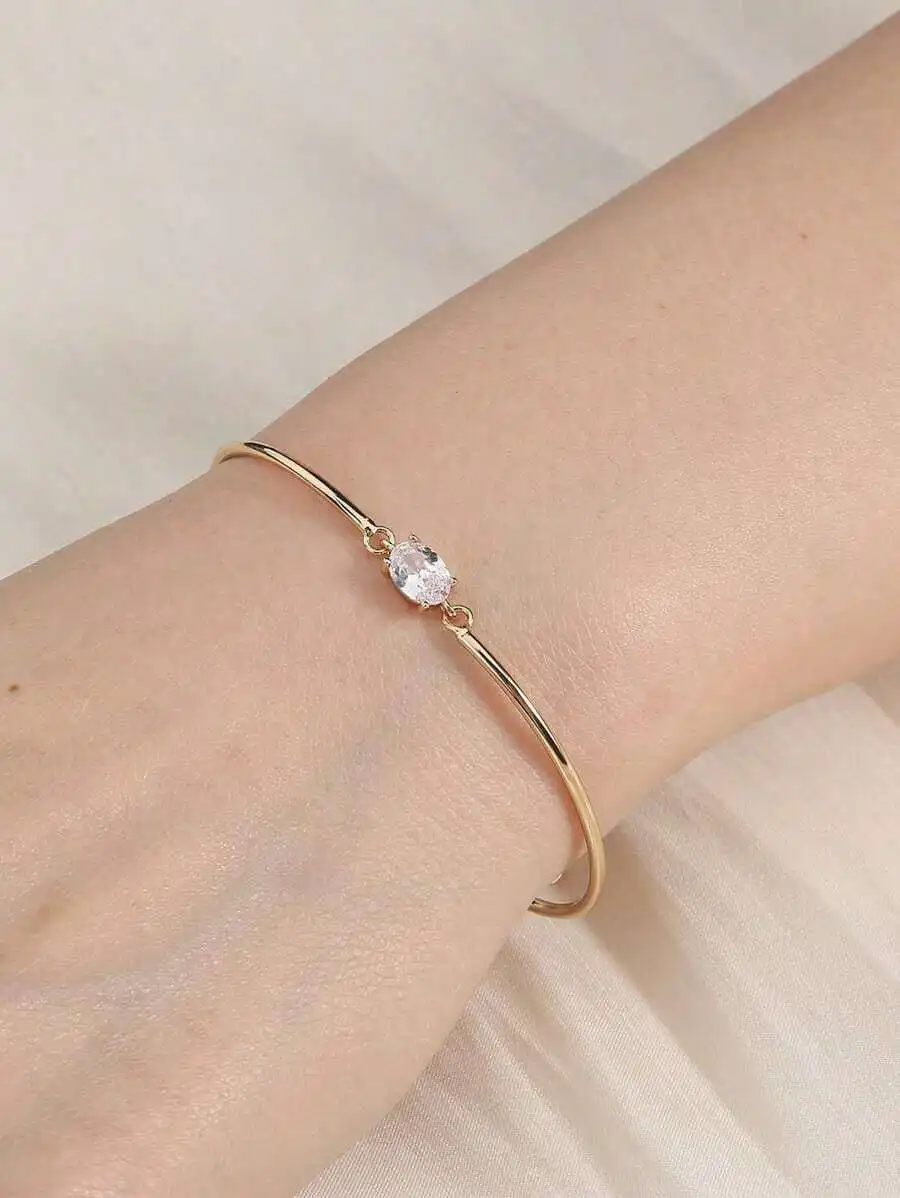Slim Open Cuff Bracelet Featuring Oval Clear Cubic Zirconia On Polished Gold-Tone Tube Design
Slim Open Cuff Bracelet Featuring Oval Clear Cubic Zirconia On Polished Gold-Tone Tube Design