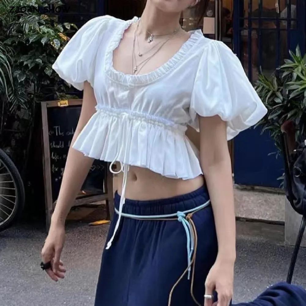 2025 Stylish White Wood ears U collar Short Puff Sleeve Shirt Women Lacing up Bandage Waist Ruffles Hem Crop Tops
2025 Stylish White Wood ears U collar Short Puff Sleeve Shirt Women Lacing up Bandage Waist Ruffles Hem Crop Tops
