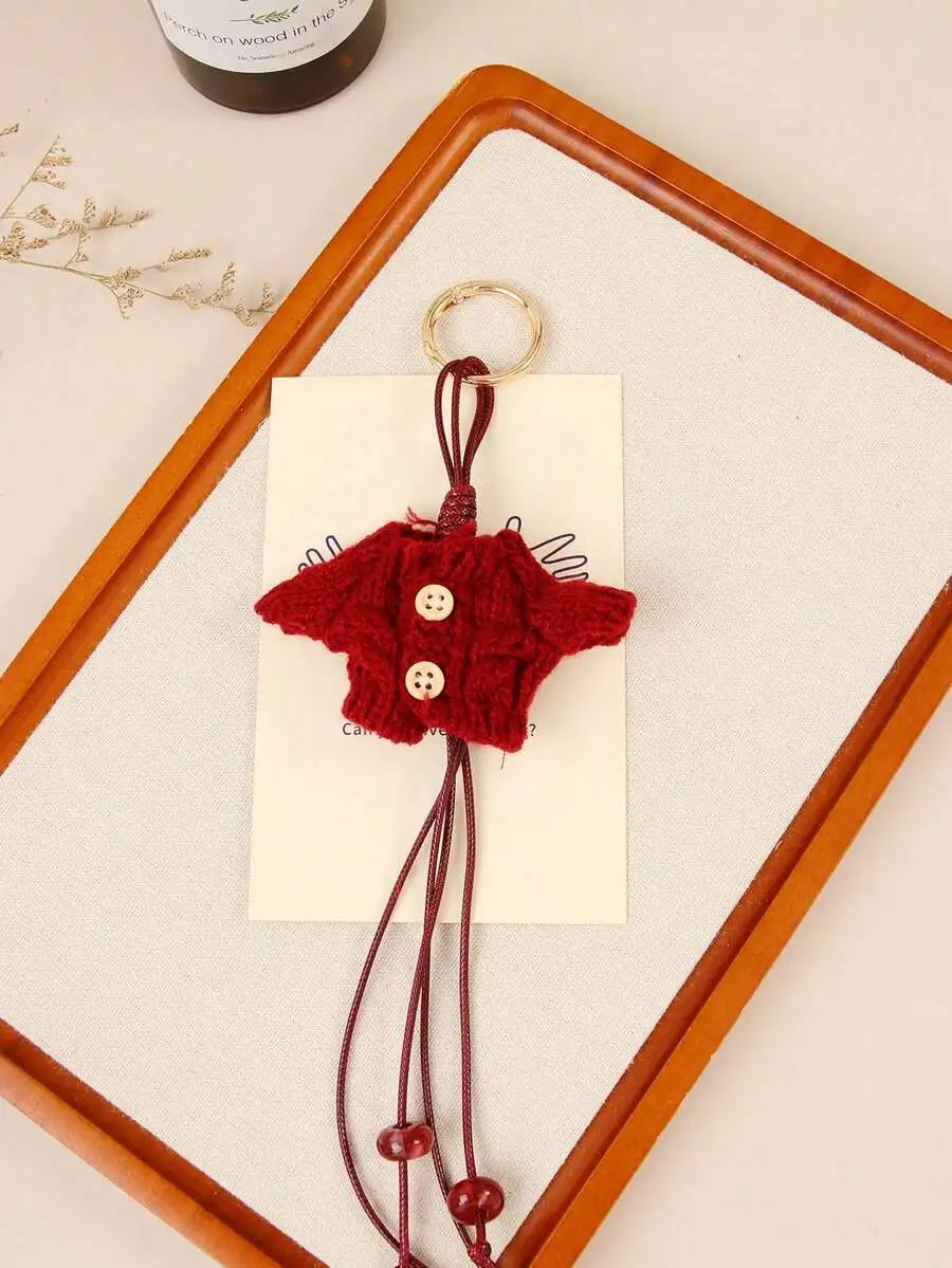 Knitted Sweater Mini Bag Charm With Beaded Tassels And Button Detail
Knitted Sweater Mini Bag Charm With Beaded Tassels And Button Detail
