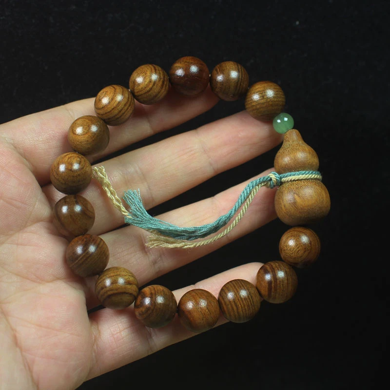 Black rosewood 12mm bracelet with green sandalwood gourd and colorful cord, unisex, simple forest-style Buddhist prayer beads an
Black rosewood 12mm bracelet with green sandalwood gourd and colorful cord, unisex, simple forest-style Buddhist prayer beads an