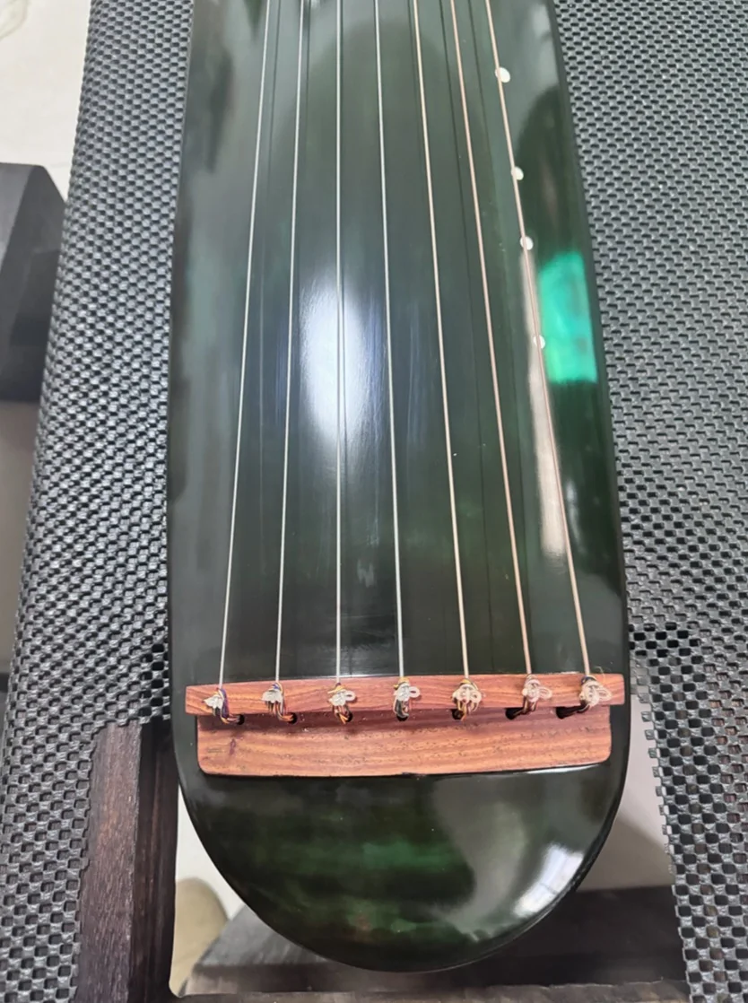 Guqin Chaotic style blackish green manual Pure raw lacquer Chinese string instruments
Guqin Chaotic style blackish green manual Pure raw lacquer Chinese string instruments