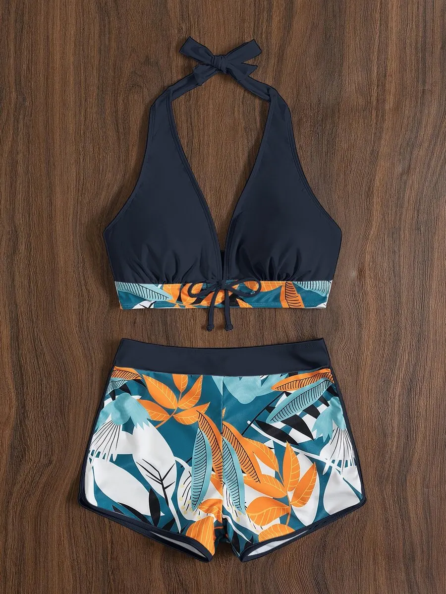 Halter Top With Front Bow Tie And High-Waisted Dolphin Shorts In Teal Orange White Tropical Leaf Print Two-Piece Swimsuit
Halter Top With Front Bow Tie And High-Waisted Dolphin Shorts In Teal Orange White Tropical Leaf Print Two-Piece Swimsuit