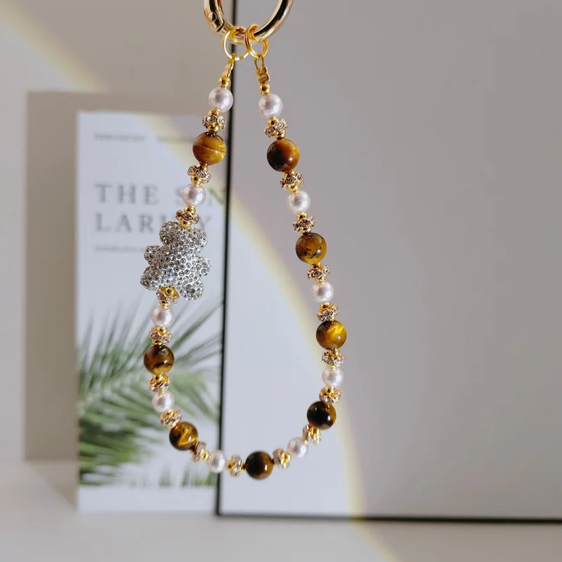 Original diamond bear phone strap with tiger pattern cat's eye stone, pearl wrist strap, short high-end pendant keychain
Original diamond bear phone strap with tiger pattern cat's eye stone, pearl wrist strap, short high-end pendant keychain