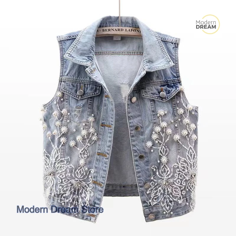 Korean version of lace beaded flower hole denim vest female spring and summer new fashion casual Joker sleeveless vest coat.
Korean version of lace beaded flower hole denim vest female spring and summer new fashion casual Joker sleeveless vest coat.