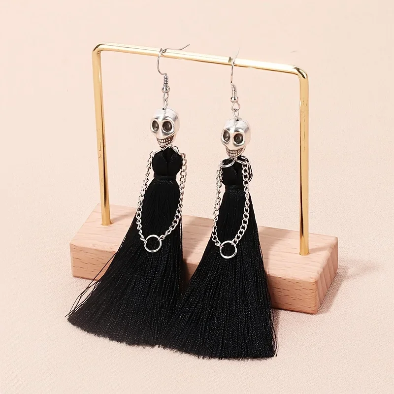 Skeleton Bride Tassel Dangle Earrings for women, featuring a silver-toned skull charm paired with a dramatic black tassel and edgy chain detail. Crafted from durable zinc alloy in a gothic party style
Skeleton Bride Tassel Dangle Earrings for women, featuring a silver-toned skull charm paired with a dramatic black tassel and edgy chain detail. Crafted from durable zinc alloy in a gothic party style