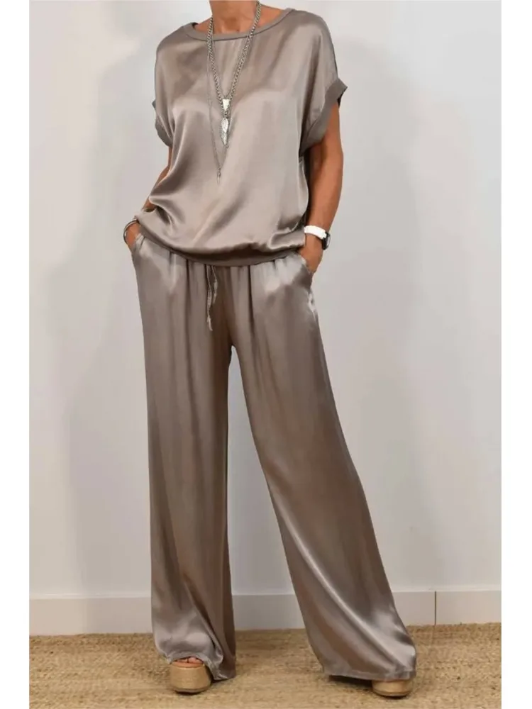 Summer Solid Color Satin 2 Piece Sets Women Outfits O-neck Short Sleeve Tops Lace-up Loose Wide Leg Pant Casual Loose Womens Set
Summer Solid Color Satin 2 Piece Sets Women Outfits O-neck Short Sleeve Tops Lace-up Loose Wide Leg Pant Casual Loose Womens Set
