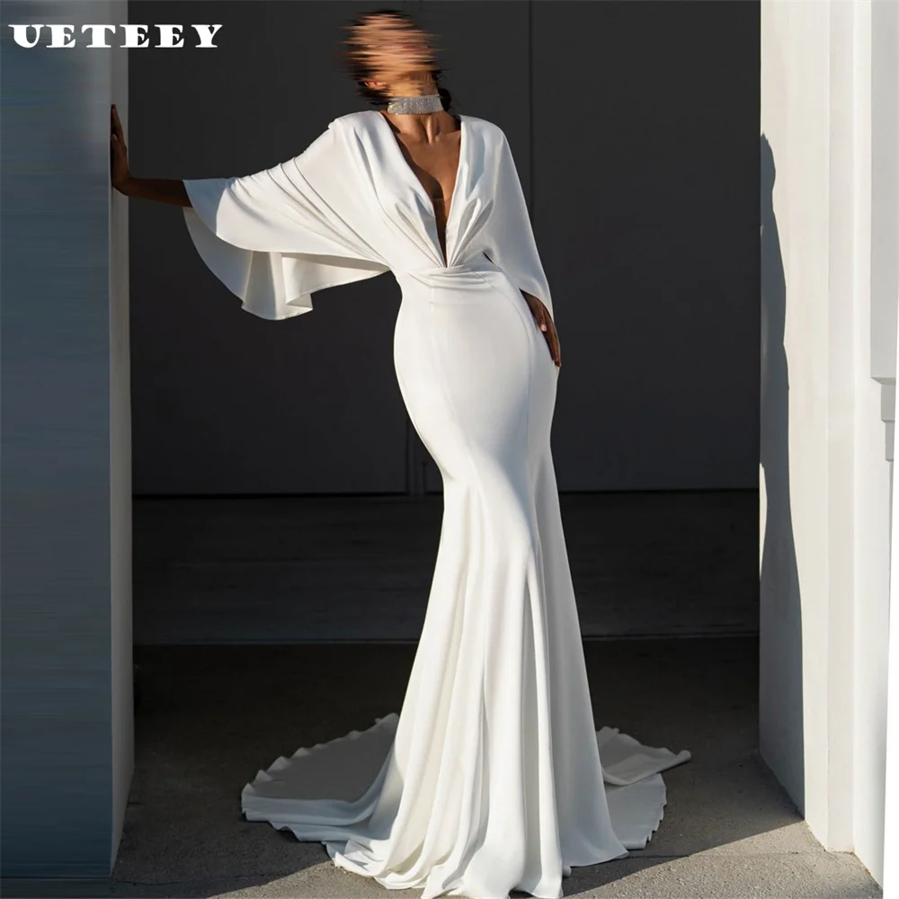 UETEEY Customized Simple Long Flare Sleeves Deep V Neck Crepe Mermaid Wedding Dress Women Illusion Back Court Train Bridal Gown
UETEEY Customized Simple Long Flare Sleeves Deep V Neck Crepe Mermaid Wedding Dress Women Illusion Back Court Train Bridal Gown