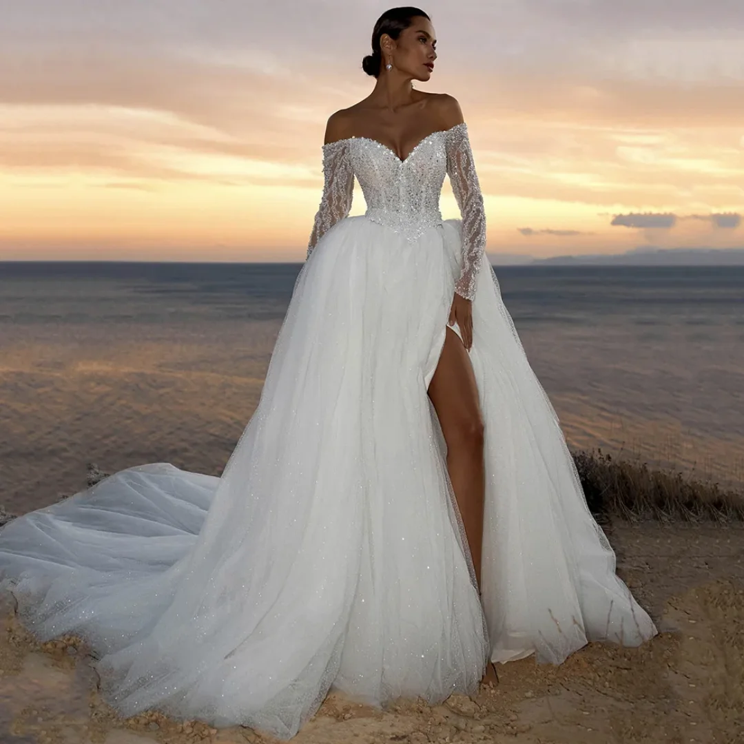 Сверкающее свадебное платье по индивидуальному заказу с глубоким V-образным вырезом и длинными рукавами, расшитое бисером, со шлейфом и разрезом, блестящее элегантное свадебное платье Vestido De Noiv
Сверкающее свадебное платье по индивидуальному заказу с глубоким V-образным вырезом и длинными рукавами, расшитое бисером, со шлейфом и разрезом, блестящее элегантное свадебное платье Vestido De Noiv