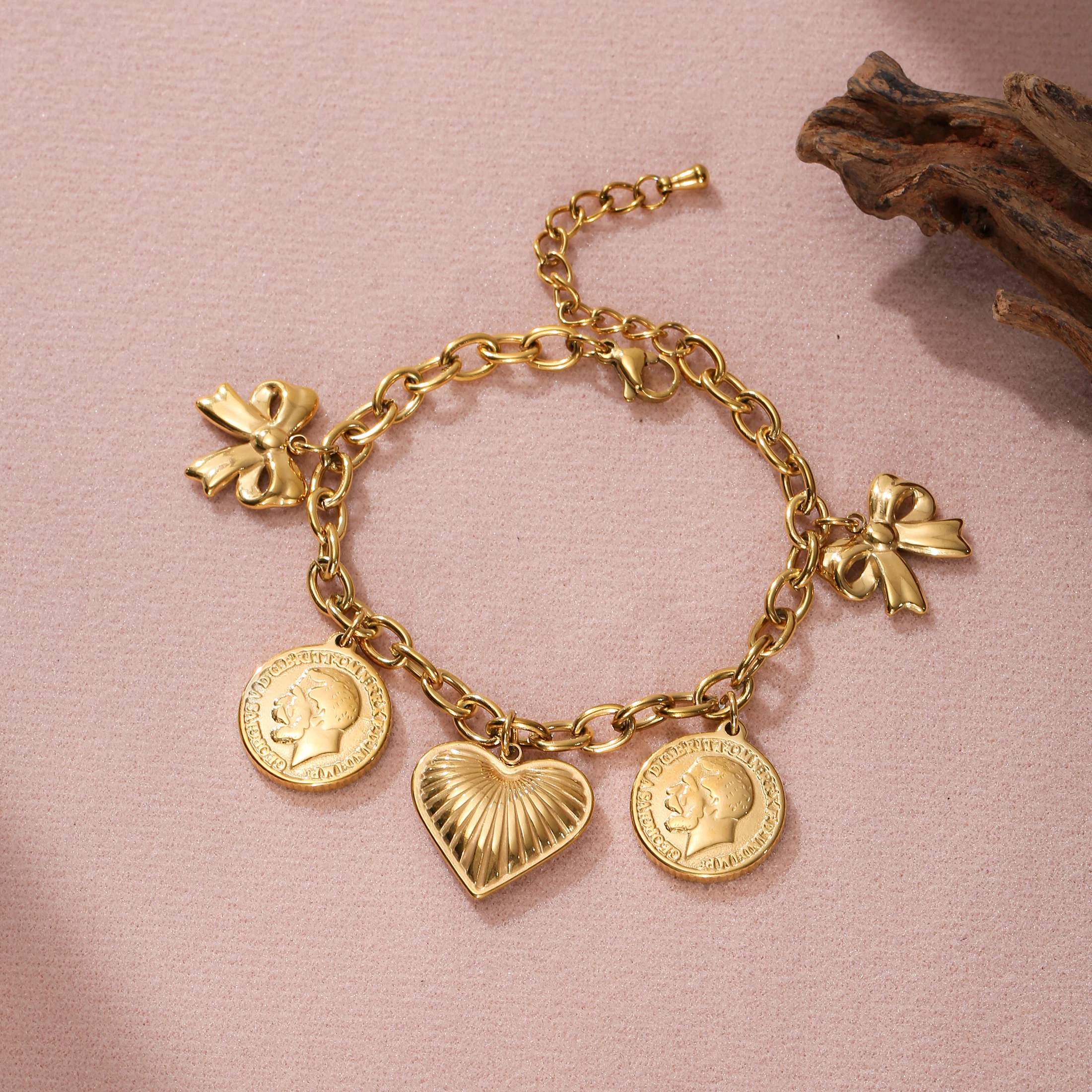 Golden Tone Stainless Steel Bow and Heart Charm Bracelet with Coin Accents for Women
Golden Tone Stainless Steel Bow and Heart Charm Bracelet with Coin Accents for Women