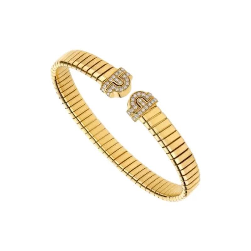 Flexible coiled gold bangle with diamond-set curved ends
Flexible coiled gold bangle with diamond-set curved ends