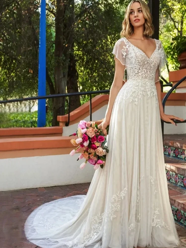 Elegant Deep V-Neck Appliqué Wedding Dress — Short-Sleeve A-Line Silhouette, Cathedral-Style Open-Back Bohemian Bridal Gown
Elegant Deep V-Neck Appliqué Wedding Dress — Short-Sleeve A-Line Silhouette, Cathedral-Style Open-Back Bohemian Bridal Gown